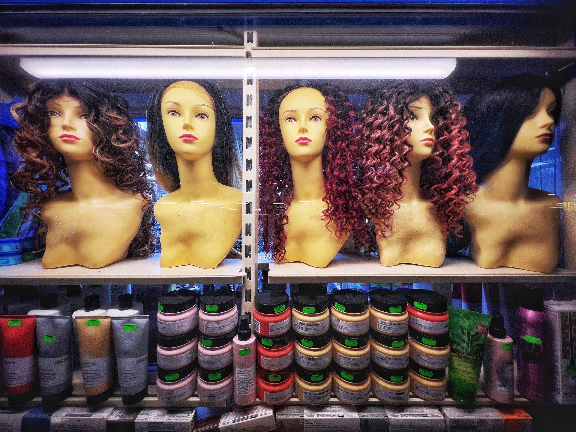 Female mannequin heads modelling wigs in shop window